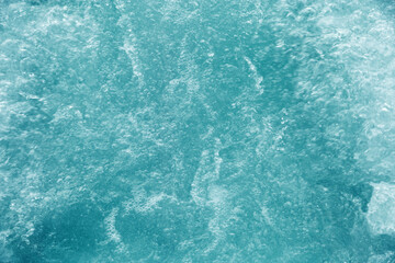 Abstract transparent water texture, bubbling clear water as textured background, purity and beauty of nature, natural ripples and waves on blue turquoise aquatic surface, nature environment