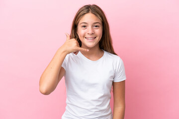 Little caucasian girl isolated on pink background making phone gesture. Call me back sign