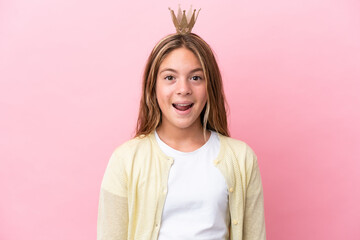 Little princess with crown isolated on pink background with surprise facial expression