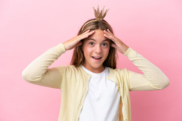 Little princess with crown isolated on pink background with surprise expression