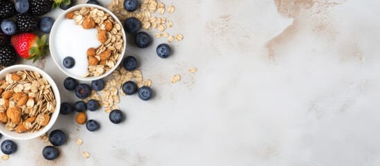 An aerial view of superfood breakfast bars with oats and blueberries on a white marble surface with copy space image.