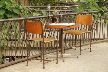 Brown wooden table and chair in the coffee cafe -  interior design vintage style - relax and chilling vibe - image from chonburi thailand