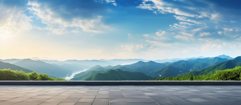 Panoramic view of natural scenery with an asphalt road and mountain range at sunrise, perfect for a copy space image.