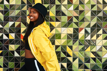 Black woman, portrait and jacket in city for fashion, stylish and wall background. Streetwear,...