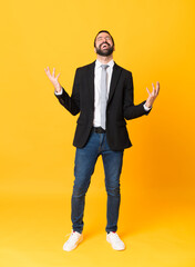 Full-length shot of business man over isolated yellow background smiling a lot