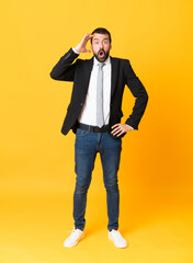 Full-length shot of business man over isolated yellow background has just realized something and...