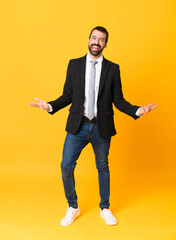 Full-length shot of business man over isolated yellow background smiling