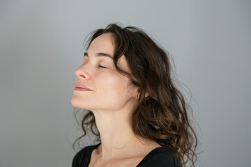 Fototapeta premium A close up of a woman's face with her eyes closed looking to a side
