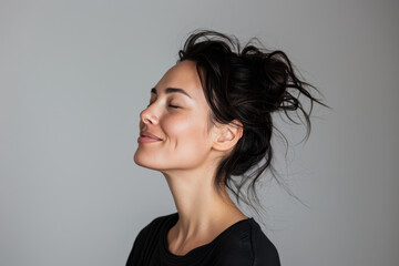 Fototapeta premium A close up of a woman's face with her eyes closed looking to a side