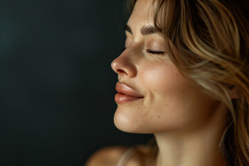 Fototapeta premium A close up of a woman's face with her eyes closed looking to a side