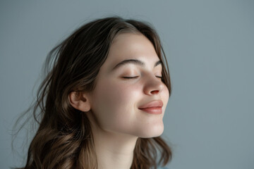 Fototapeta premium A close up of a woman's face with her eyes closed looking to a side
