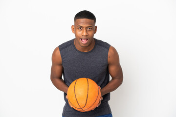 Young latin man isolated on white background playing basketball and pointing to the front