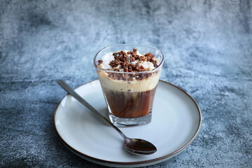 Iced caramel latte topped with whipped cream and caramel sauce, refreshing and sweet coffee drink