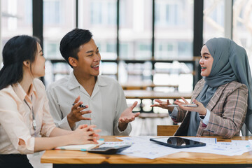 Businesswoman leading a team meeting in an office.