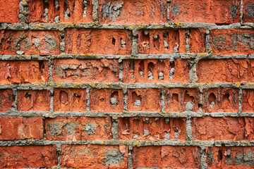 Old brick red wall, brickwork from an old brick in rustic style. Structure and pattern of destroyed stone grunge wall.  Retro style background. Copy space.