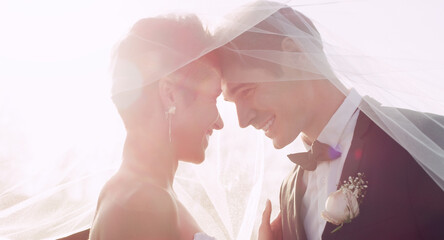 Couple, forehead and wedding veil in nature for unity, marriage and commitment at ceremony. People, touch and loyalty in relationship, partnership and trust in support or together for celebration