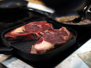 beef cutlets in a frying pan