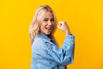 Young Russian woman isolated on yellow background celebrating a victory