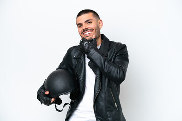 Young caucasian man with a motorcycle helmet isolated on white background happy and smiling