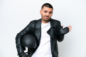 Young caucasian man with a motorcycle helmet isolated on white background having doubts while...