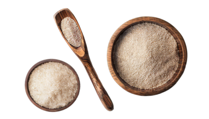 Bowl and spoon with active dry yeast isolated on white