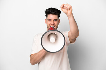 Young caucasian man isolated on white background shouting through a megaphone to announce something