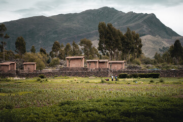 Rural countryside landscape with the small village of Raqchi and its church standing out. This town is famous for its inca archaeological site. Altiplano, Peru, South America