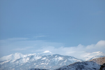Cold snowy mountain landscape at sunset.