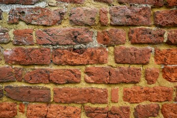 Vintage aged red English brickwork with yellow mortar.