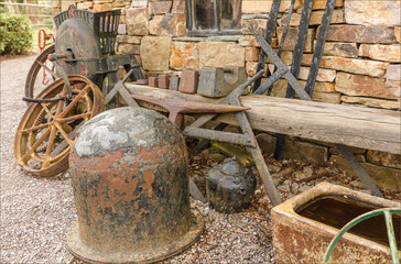 Pile of old metal items outside agaist the wall