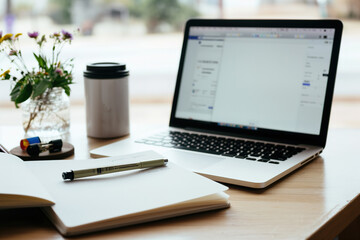 Home Office Workspace with Laptop, Notebook, and Coffee Mug