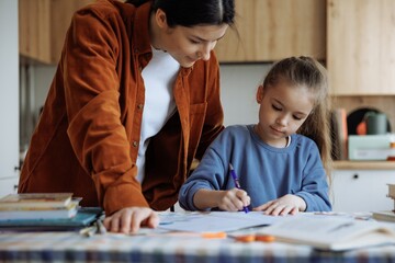 The daughter and her mother do their school homework