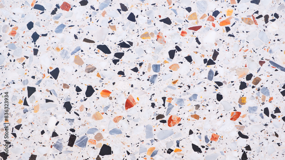 Poster a background with a lot of different colored rocks scattered all over it. the rocks are of various s