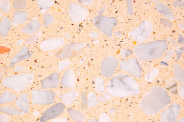 A background with a lot of different colored rocks scattered all over it. The rocks are of various sizes and colors, creating a visually interesting and unique pattern