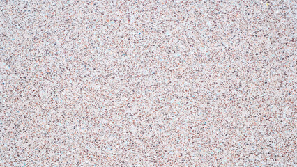 A background with a lot of different colored rocks scattered all over it. The rocks are of various sizes and colors, creating a visually interesting and unique pattern