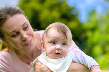 Mother Holding Baby Close-Up Outdoors