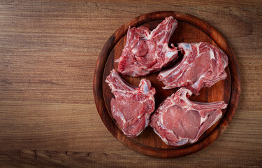 raw calf meat, meat on the bone, meat for barbecue, cutting board, top view,