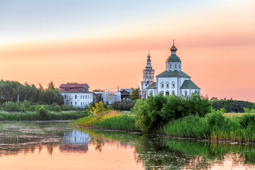 SUZDAL, RUSSIA - Beautiful landscape of Suzdal overlooking the Kamenka River and the ancient Russian Church of Elijah the Prophet (Ilyinsky Church)At sunset