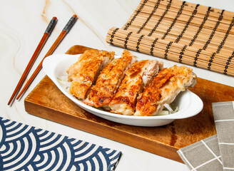 Italian Chicken Leg Steak Slice with chopsticks served in dish isolated on wooden board and napkin side view of taiwan food