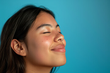 Fototapeta premium A close up of a woman's face with her eyes closed looking to a side