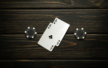 A lucky omen or winning poker hand on a vintage casino table made from two aces and chips