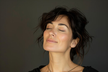 Fototapeta premium A close up of a woman's face with her eyes closed looking to a side