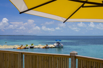 Fototapeta premium Boat and water scooters at the beach side in Caribbean Islands.