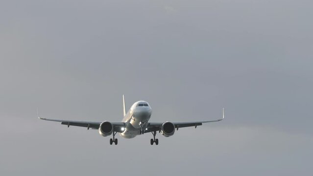 Jet airplane approaching landing at Phuket airport. Passenger flight is flying overhead