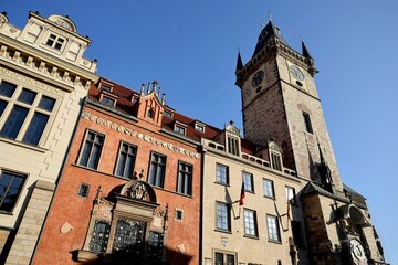 Clock tower of a European building seen from a low angle