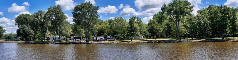 Panorama of travel trailers camping by the Mississippi river in Illinois at Thomson Causeway