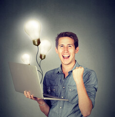 Man using a laptop with light bulbs plugged in it