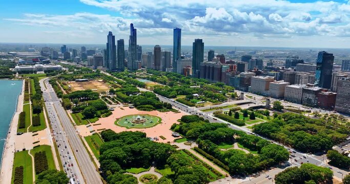 Huge city park Grant Park in Chicago Loop area, Chicago, Illinois, the USA. Beautiful green area neighboring with diverse buildings. Aerial view.