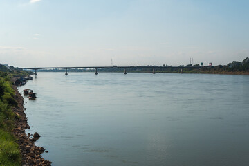 A river with a bridge in the background