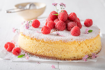 Tasty and fresh cheesecake decorated with mint and raspberries.